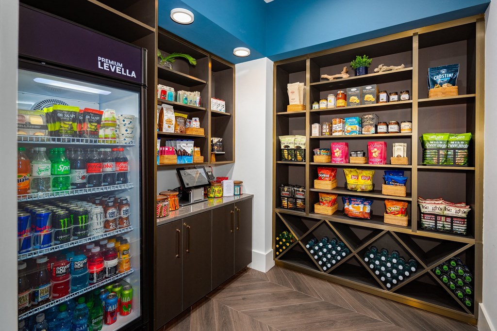the store has a large refrigerator and shelves of food and drinks