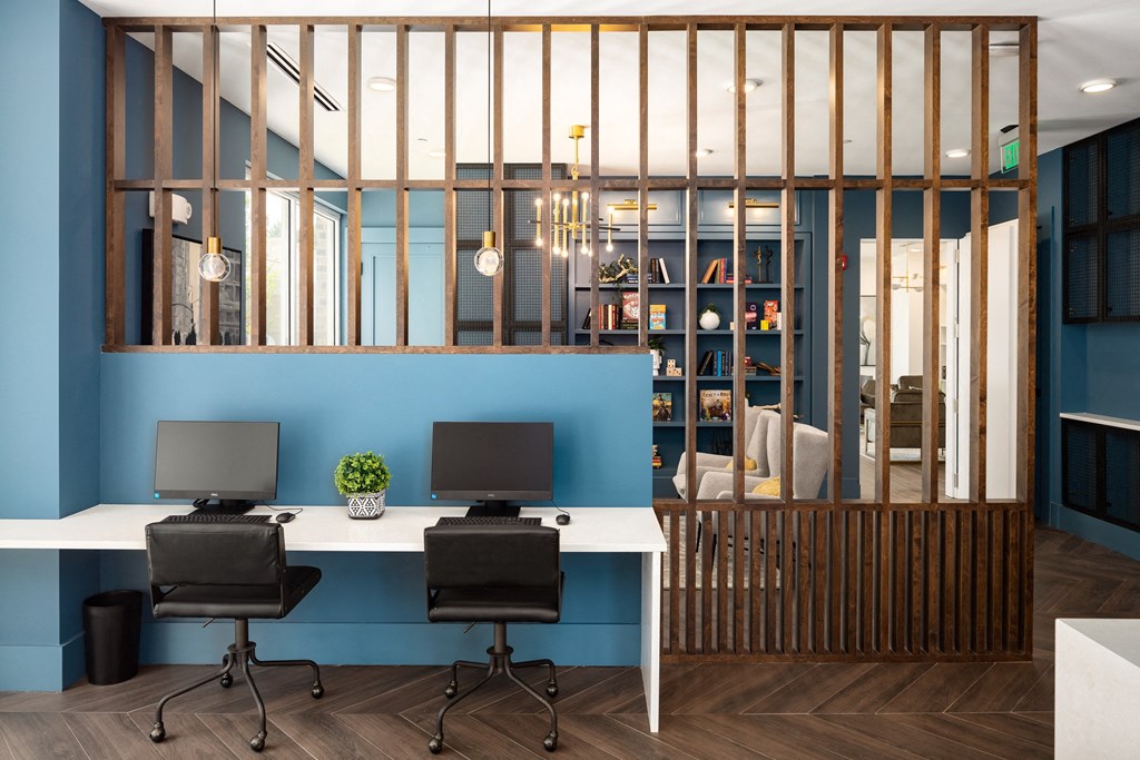 a modern office with two desks and two chairs