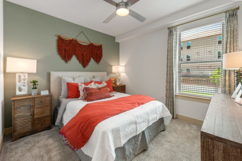 a bedroom with a bed and a ceiling fan