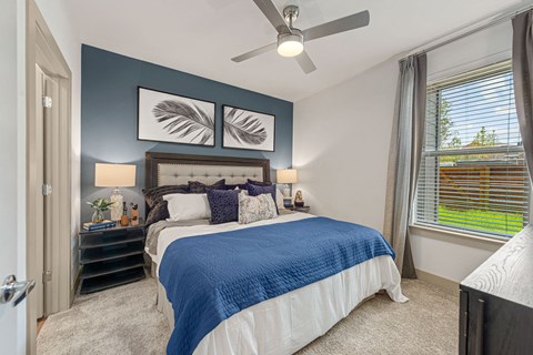 a bedroom with a bed and a ceiling fan