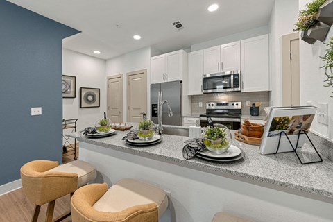 a kitchen with a counter with plates of food on it