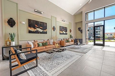 a living room with couches and a large glass door