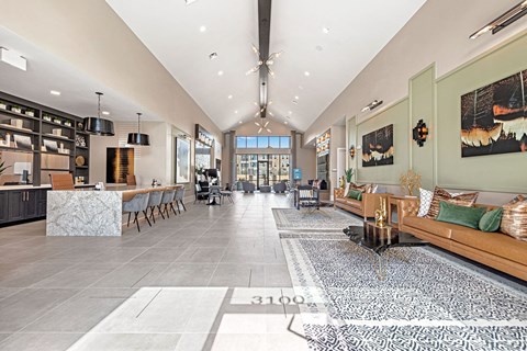 a large living room with couches and a kitchen with a table and chairs