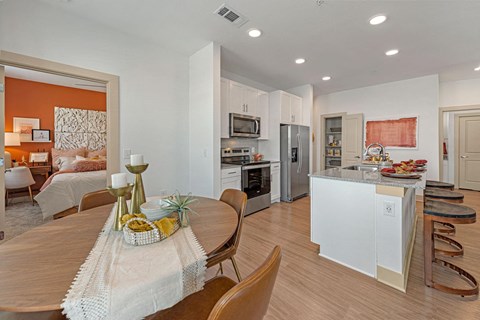 a kitchen and dining room with a table and chairs