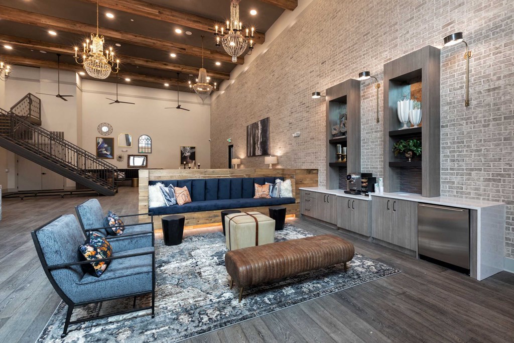a living room with a blue couch and a kitchen