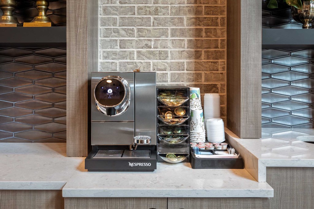 a coffee machine sitting on a counter in a hotel lobby