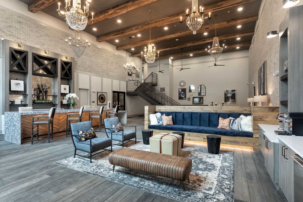 a living room with couches and chairs and a kitchen