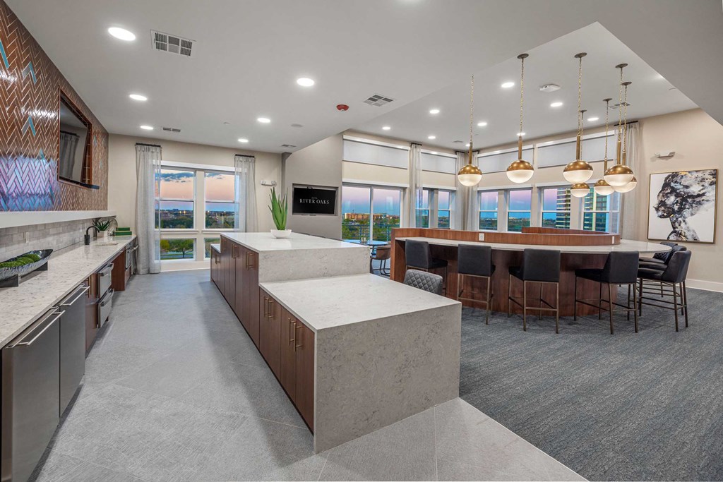 a large kitchen with a bar and a dining room