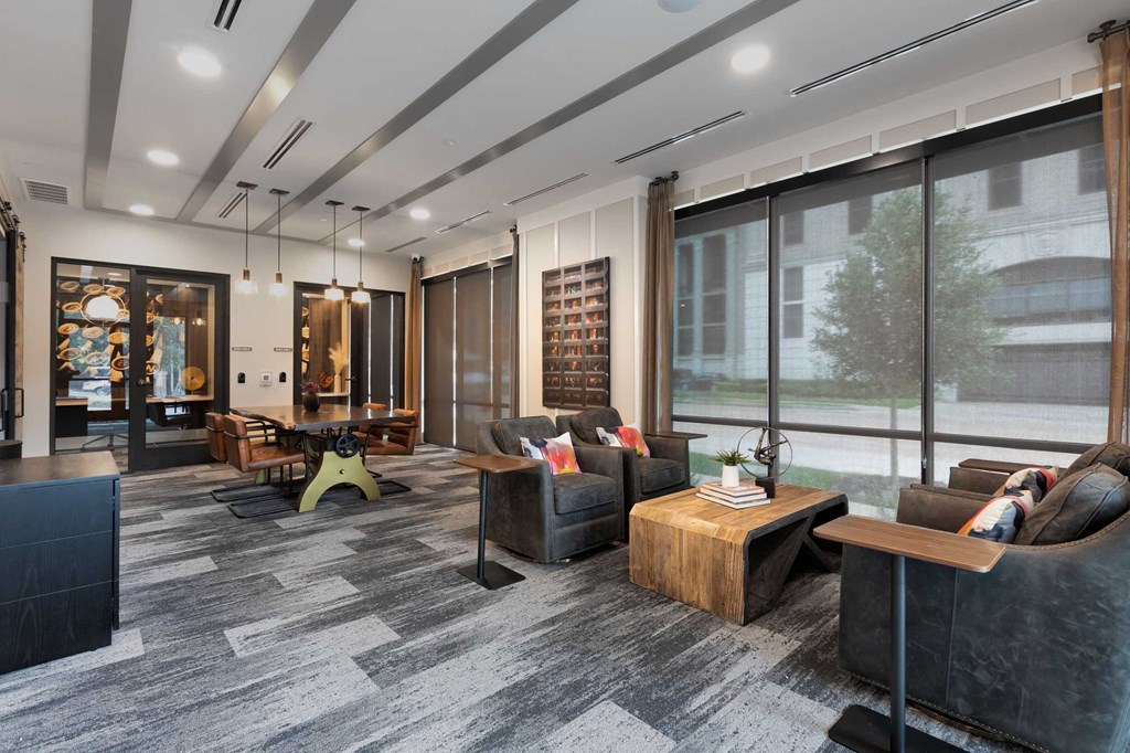 a lobby with couches and tables and large windows