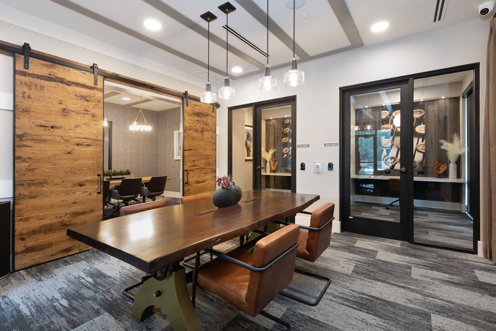 a conference room with a wooden table and chairs