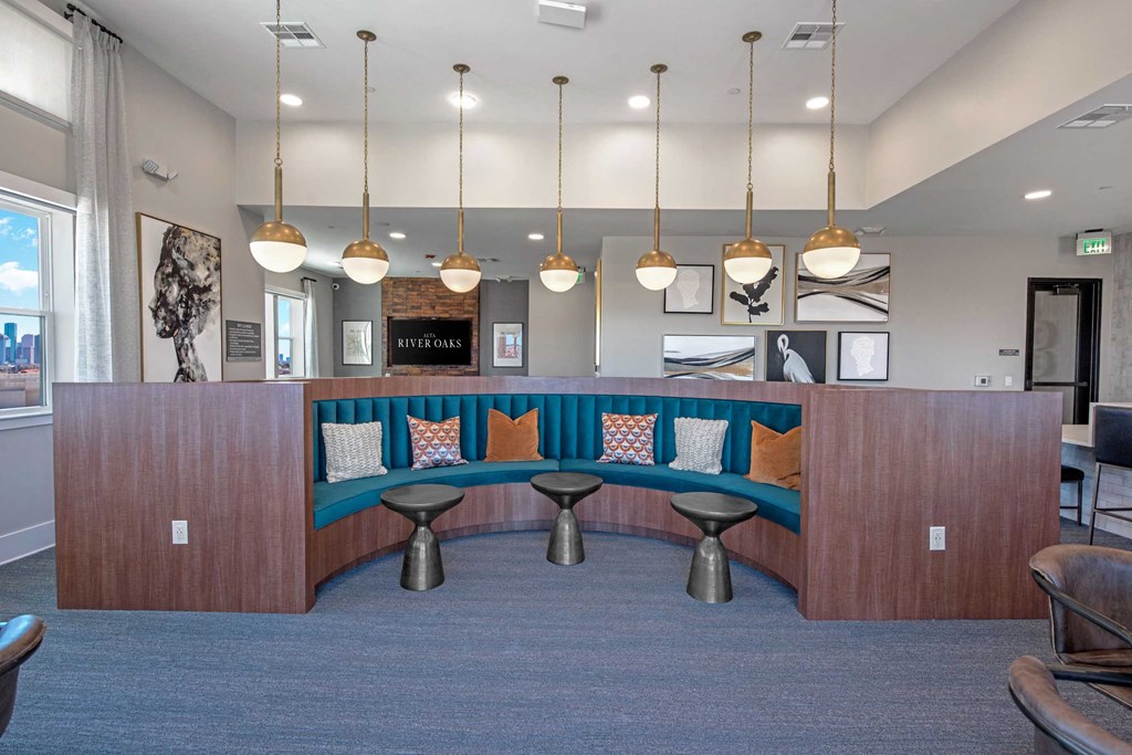 a lobby with a blue couch and tables