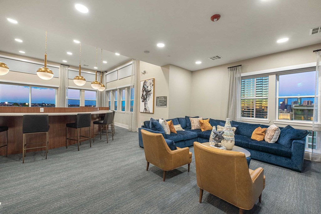 a living room with couches and chairs and a bar