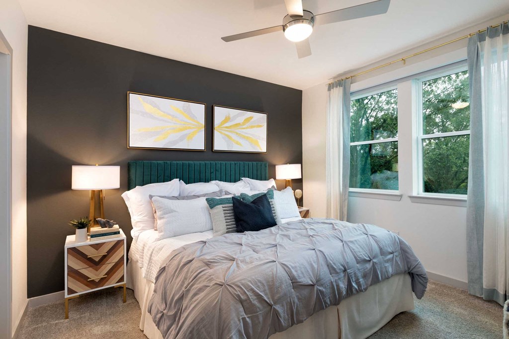 a bedroom with a bed and a ceiling fan