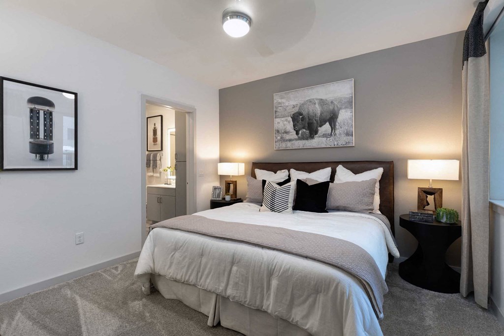 a bedroom with a bed and a painting of a bear