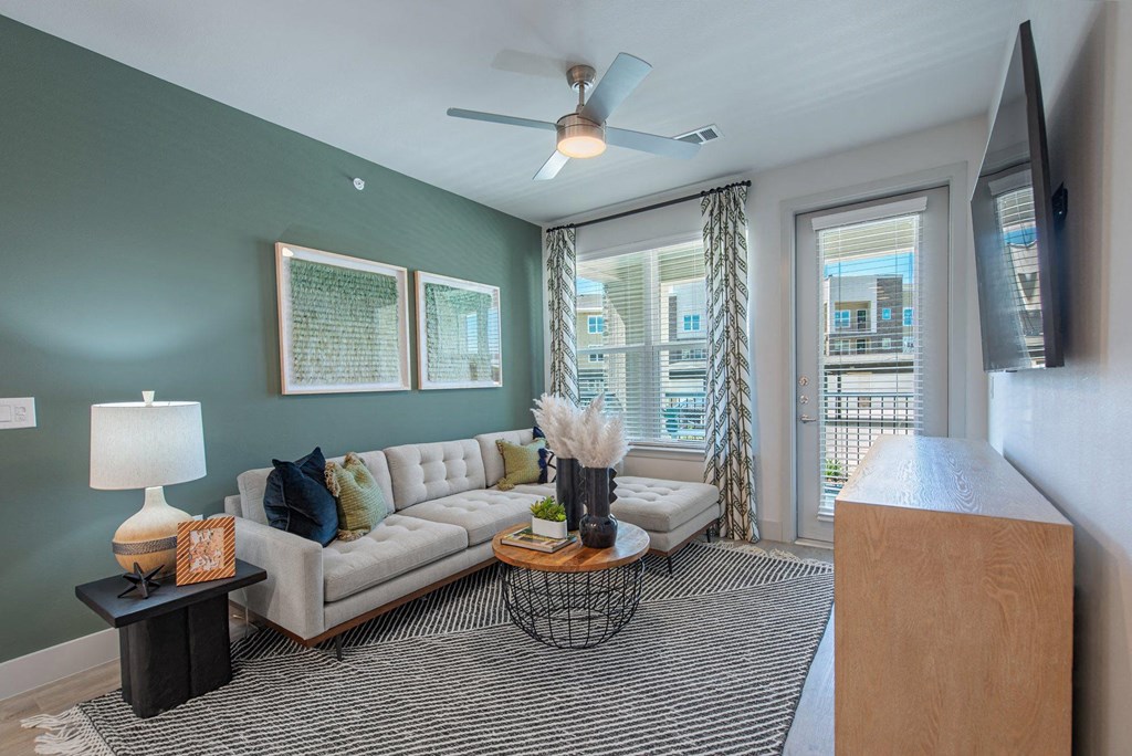 a living room with a couch and a ceiling fan