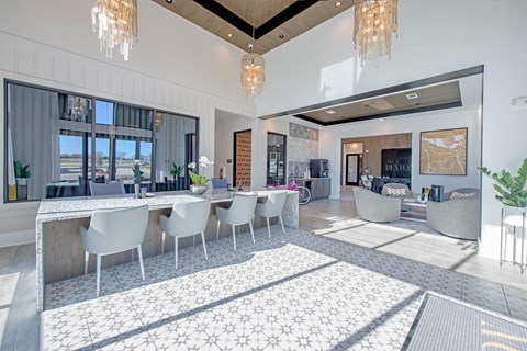 a large living room with a long table and chairs
