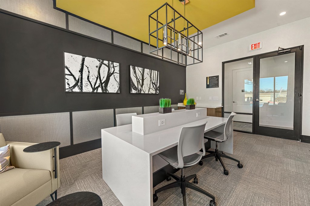 a conference room with a white desk and chairs