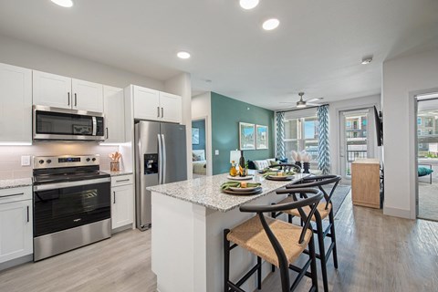 a kitchen with stainless steel appliances and a marble counter top