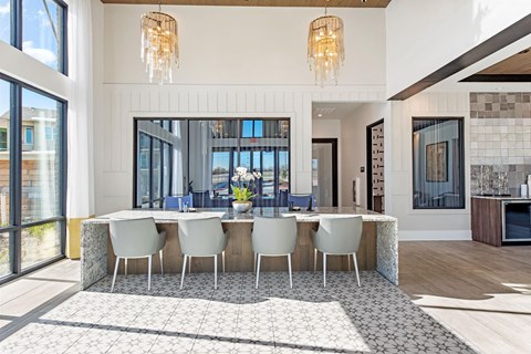 a dining room with a long table and chairs