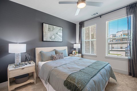 a bedroom with a large bed and a ceiling fan