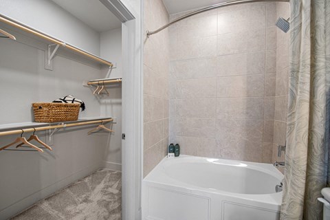 a bathroom with a tub and a shower and a curtain