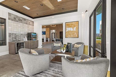 a living room with chairs and a table