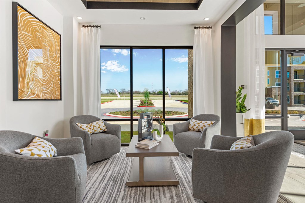 a living room with couches and chairs and a table