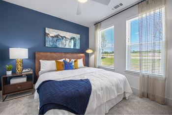 the residence with blue accent wall and large windows