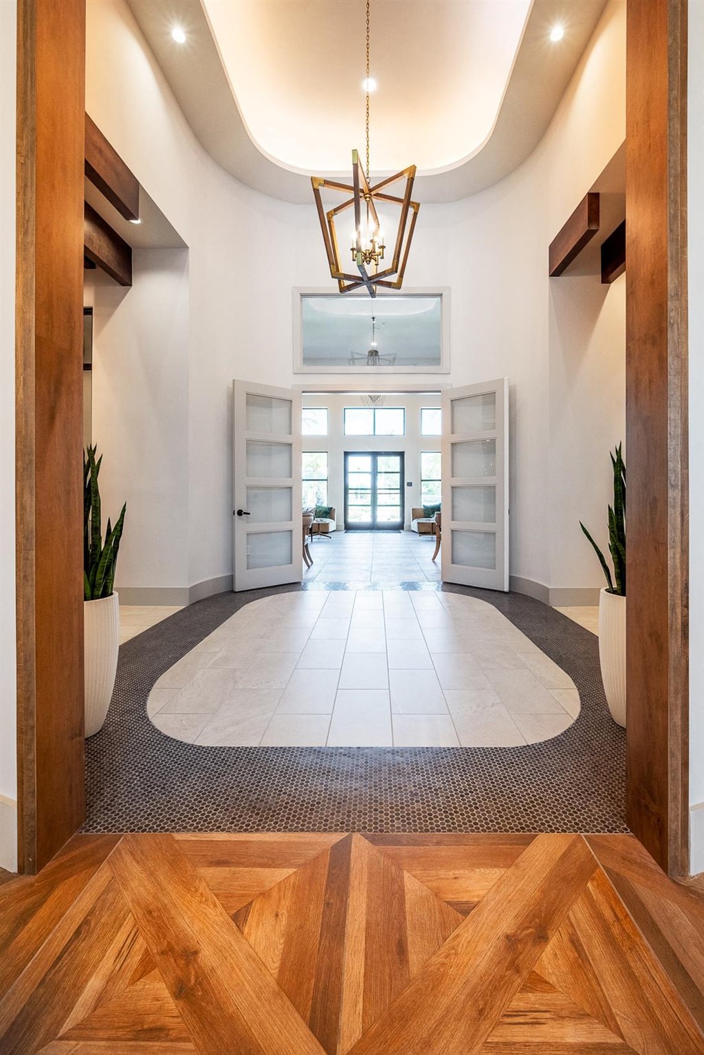 a view of a large lobby with wood floors and a chandelier