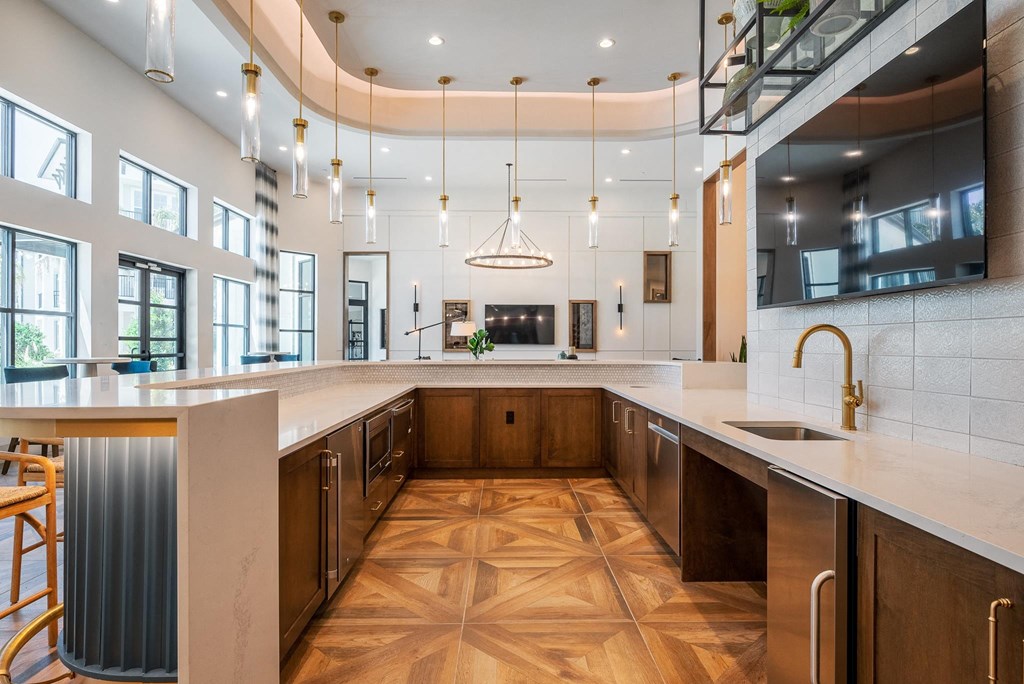 a large kitchen with marble counter tops and wooden floors