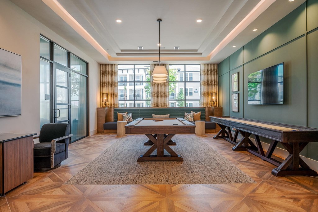 a large living room with a large table and a ping pong table