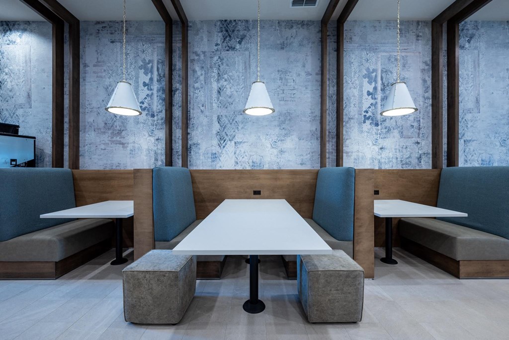 a communal table in a restaurant with chairs and tables