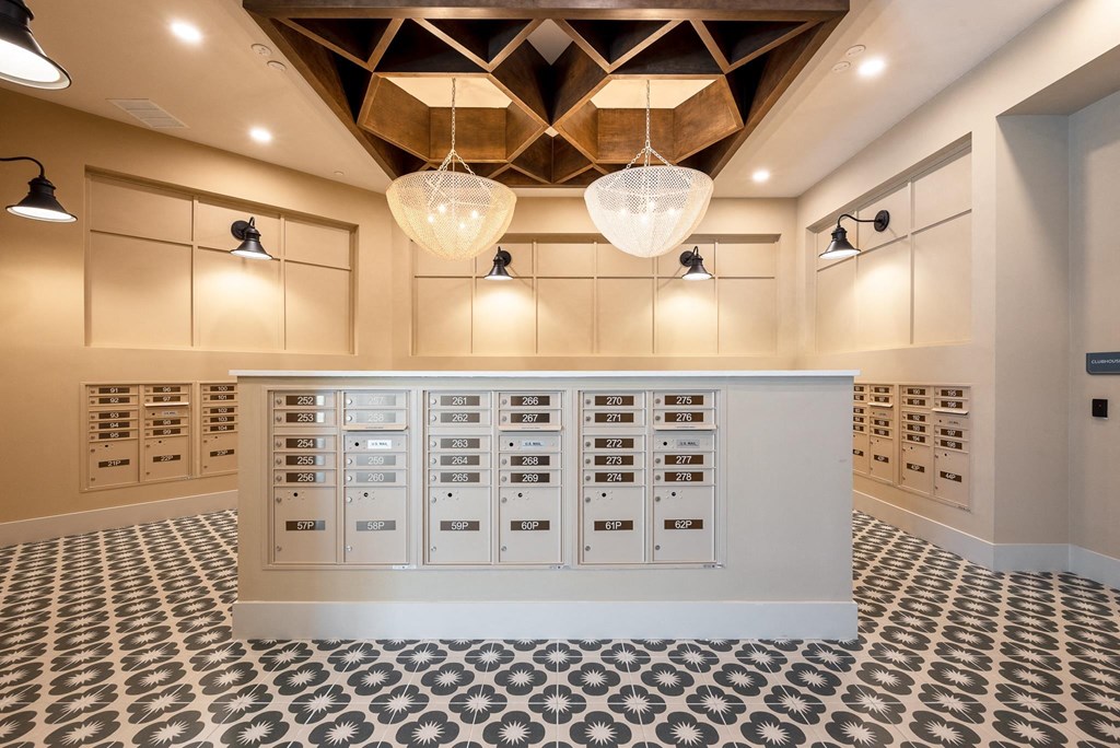 the vaulted ceiling in the laundry room is lit by hanging lights and a counter
