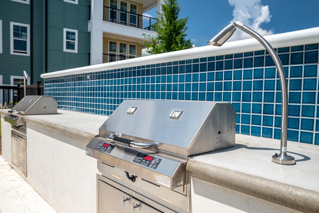 a hot tub in front of a blue tiled building