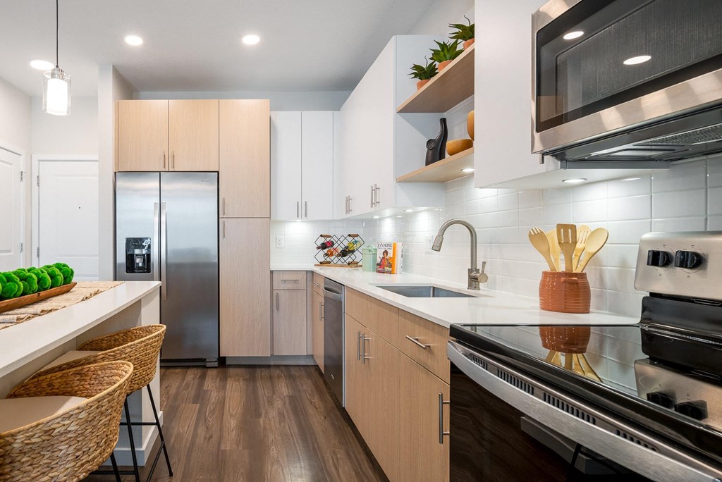 a kitchen with white cabinets and a stainless steel refrigerator