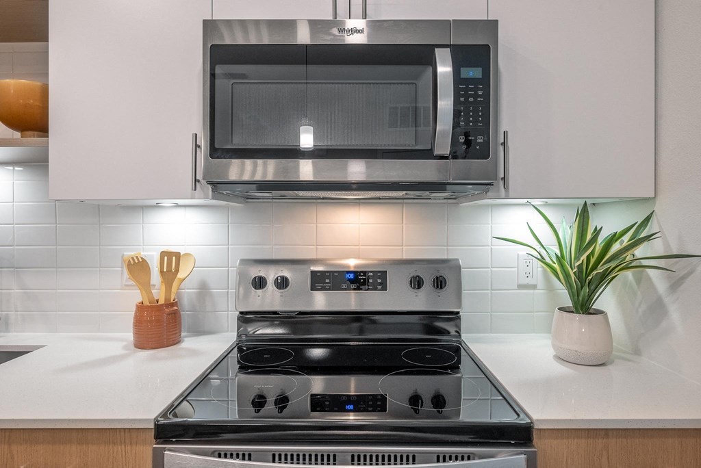 a kitchen with a coffee maker and a microwave on the wall