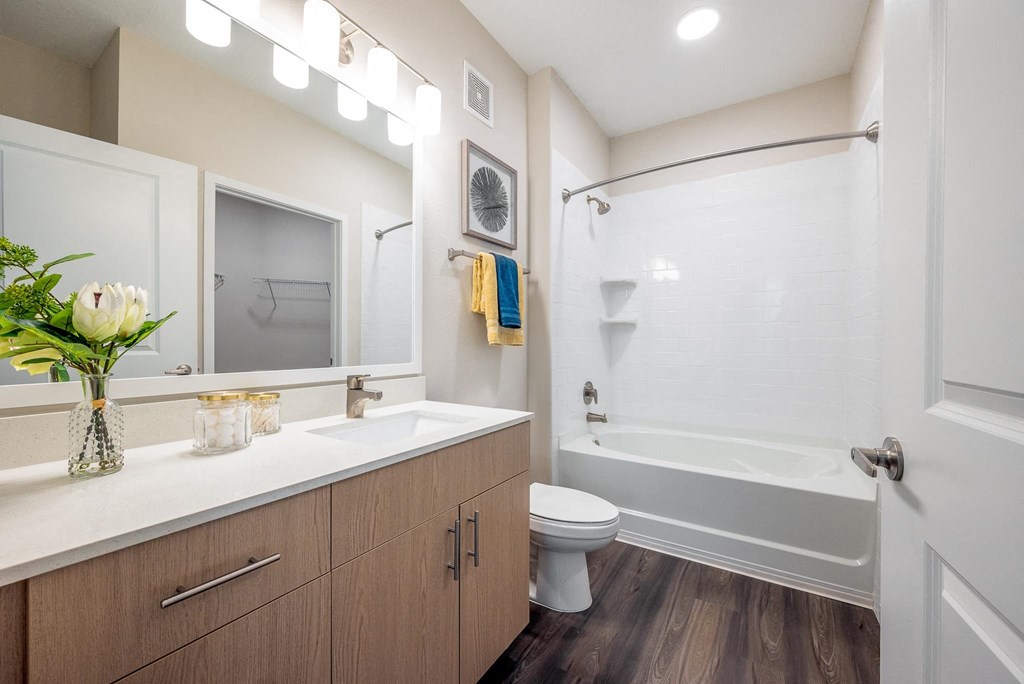 a bathroom with a toilet and a shower and a sink