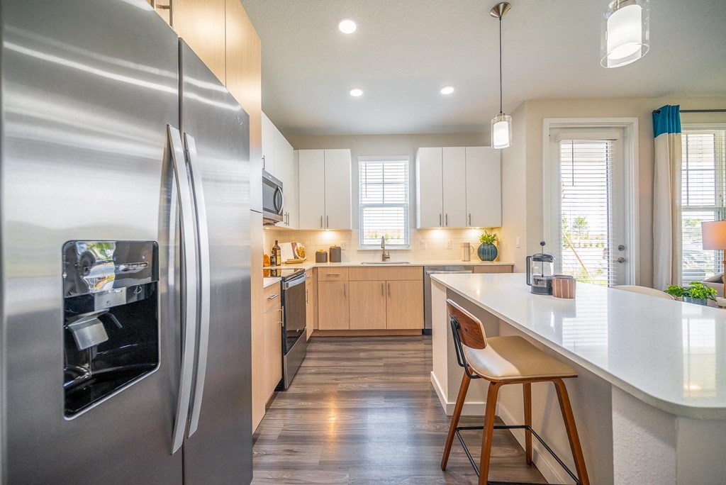 a kitchen with stainless steel appliances and a white counter top