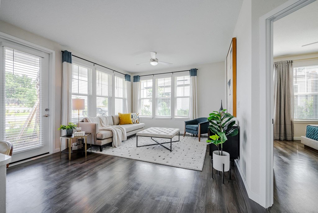 a living room with a couch and a coffee table    and a window