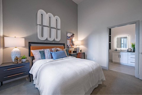 a bedroom with a large bed and a mirror