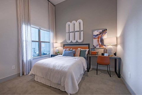 a bedroom with two beds and a desk