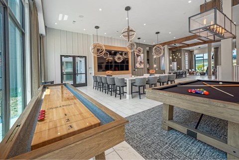 a game room with a pool table and a bar