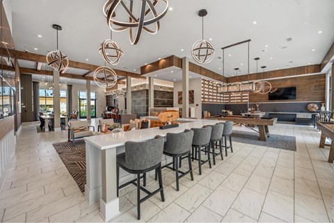 the lobby of a restaurant with a bar and tables