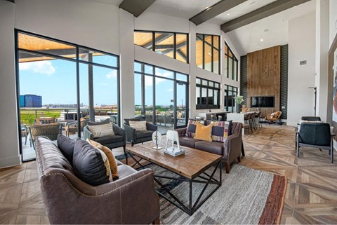 a living room with couches and chairs and a table with a fireplace
