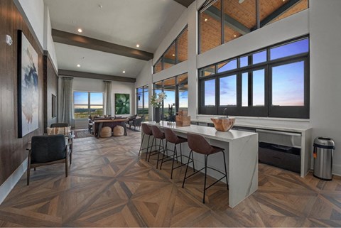 a large living room with a dining room and a table with chairs