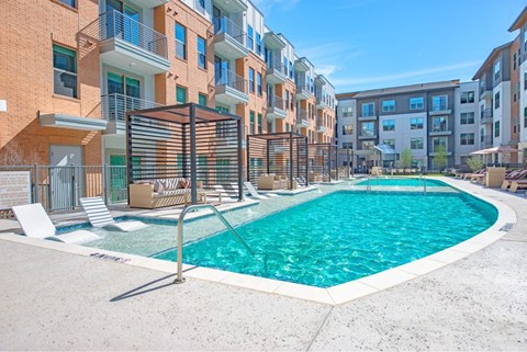 a swimming pool in front of an apartment building