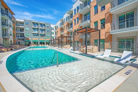 a swimming pool in front of an apartment building