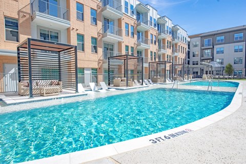 a swimming pool in front of an apartment building