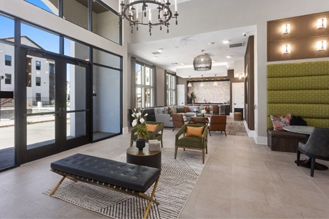 a lobby with a seating area and a chandelier