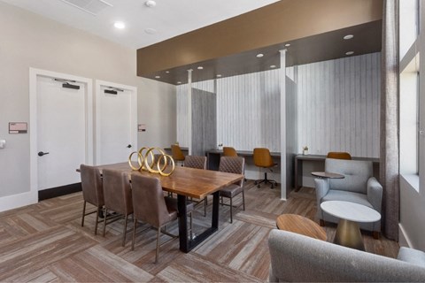 a dining room with a wooden table and chairs